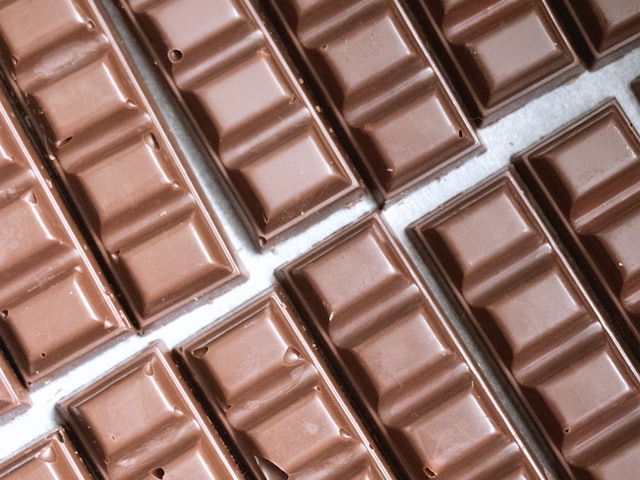 Rows of unwrapped chocolate bars laid edge to edge