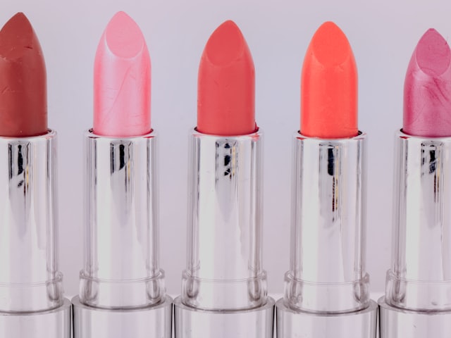 Five lipsticks in a row, shades running from red to pink